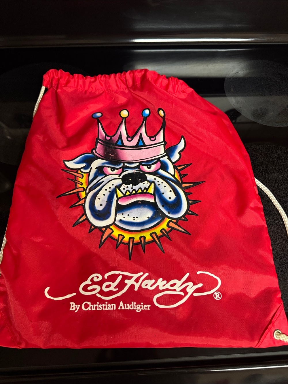 Ed Hardy Red Drawstring Backpack with Multicolor Crowned Bulldog Rate
